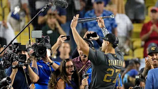 Giancarlo Stanton holds up the MVP award.